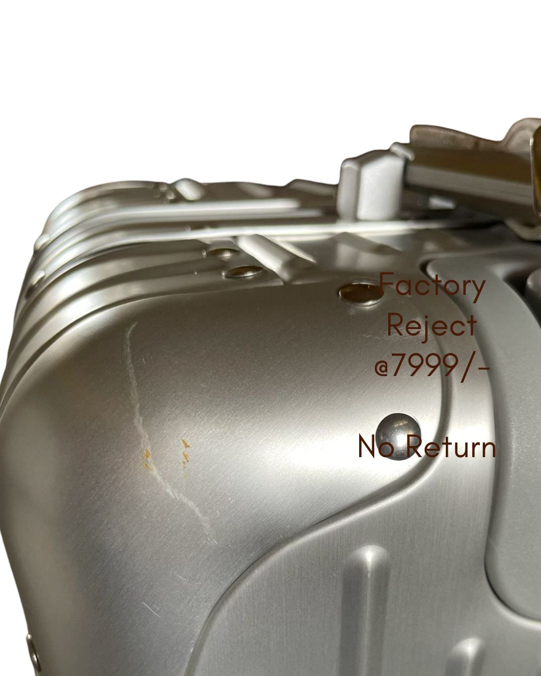 Metallic object with 'Factory Reject' and 'No Return' text on a white background